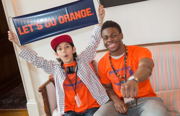Students holding a Let's Go Orange sign